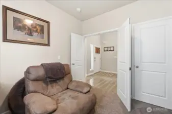 TV room has double door just off the entry-way