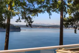 Panoramic outlook captures sparkling water and stunning  Olympic Mountain vistas.