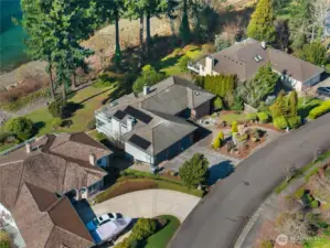 Elevated aerial view highlights the home’s privacy, setting, and proximity to the shore.