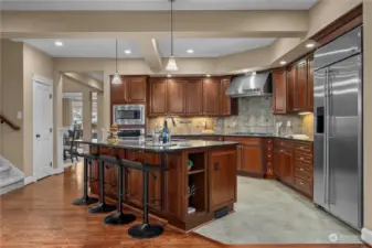 Indulge your culinary senses in this chef's kitchen, equipped with high-end appliances and ample space for culinary creations. Walk-in pantry for more storage.