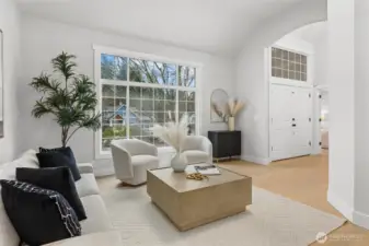 Formal living room with floor to ceiling windows and vaulted ceiling