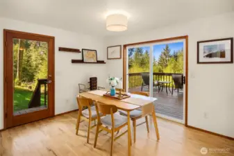 Sliding door to back deck and side door leading out to backyard.