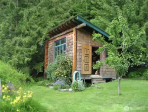The storage building/shop is additional storage or a place to create.