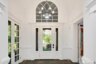 Elegant foyer with Extensive millwork, French doors and attention to detail make this home shine.