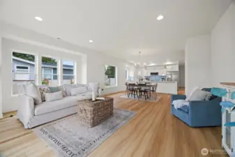 Looking across the living room toward the dining area with the kitchen beyond. This builder always has the best open floor plans!