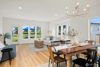 Another view across the dining area toward the living room with the water views beyond.