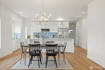 The dining room is very spacious and open to the living room and kitchen. The front entry is just to the right of the kitchen and down the hall.
