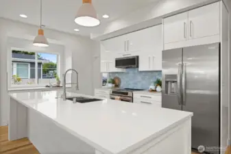 Another view of this beautiful, sleek kitchen with the gorgeous blue tile backsplash that mimics the water.
