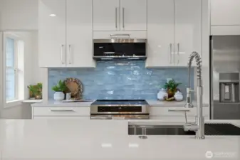 The backsplash is such a focal point of the kitchen and an absolute work of art! All the appliances are sleek...even the microwave!