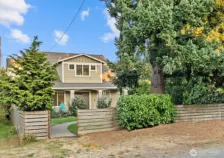 House from street. Private behind fence.