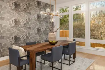 Floor to ceiling window wall perfectly frames dining room with outlooks to mature specimen maple tree and professional landscaping