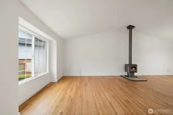 Enter into the spacious living room w/wood burning stove
