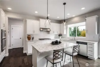 Gas cook top with subway tile behind it.  with pendant lighting, huge quartz island, quartz counters, luxury vinyl flooring and high ceilings.