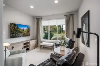 Den has custom-built bookshelves and cabinetry.