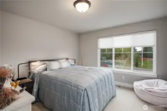 The second bedroom has white millwork, custom paint and is very light.