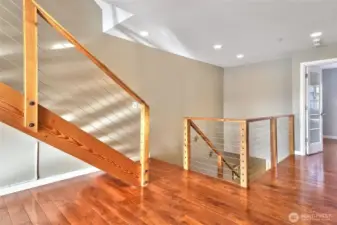 Stairs lead to the primary bedroom and another guest bedroom.