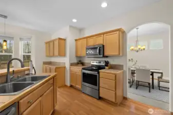 A bright and functional kitchen with seamless flow to gathering spaces—perfect for entertaining while staying connected.