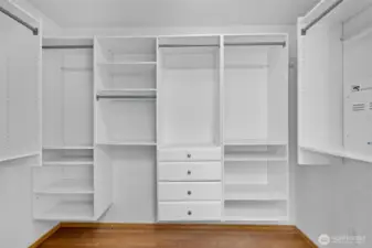 A generous walk-in closet with built-in organization makes wardrobe storage effortless and refined.