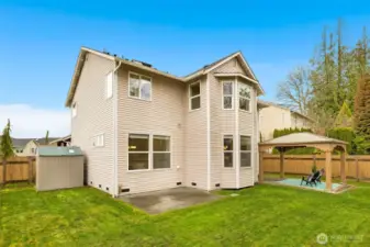 The rear façade showcases generous square footage, thoughtful design, and seamless connection to the outdoor living spaces.