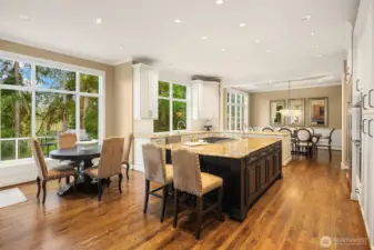 A large, adjacent breakfast nook that overlooks the South-facing back yard.  Floor-to-ceiling windows provide natural light throughout the main level.