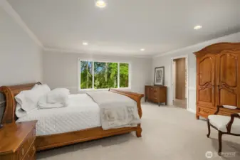 Spacious primary suite ~ serene views of the greenbelt. Large, lavish, spa-inspired en-suite bath with frame-less glass door dual head shower, heated Travertine tile floors, soaking tub, and large walk-in closet.