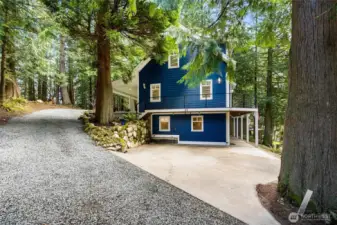 Large driveway with an additional parking spot to the left.