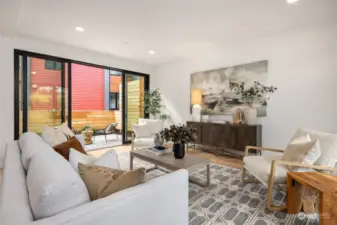 The spacious living room provides access to both the front patio and back garden through large sliding glass doors, creating a seamless indoor-outdoor flow that enhances the sense of space and natural light.