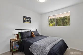 One of three bedrooms on upper level, has views of the street and a large closet.
