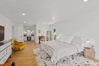 Private primary suite with hardwood floors, recessed lighting, access to wrap around deck, walk-in closet and newly renovated ensuite bathroom.