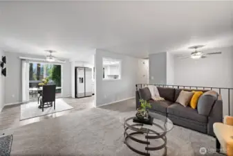 Looking into the dining area with the slider beyond which opens to the back deck with the kitchen to the left