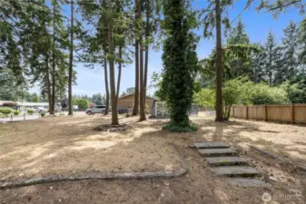 Looking towards the back of the yard, this blank canvas is ready for you to personalize and create your own private oasis!