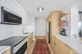 Kitchen lighting by American designer, Kelly Wearstler, provides an artful play and adds to the minimalist, modern finishes.