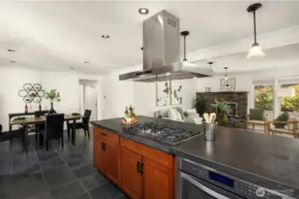 The industrial style 5-burner stove and statement extraction hood above is a central design feature of this updated, move in ready home.