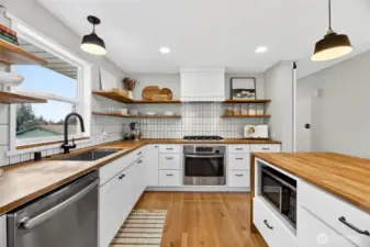 Pendant lights. Stainless steel appliances, Butcher Block countertoops.