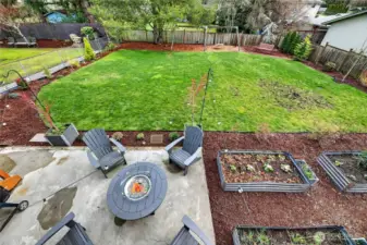 Your view from the upper deck looking to the backyard. Hang spaces, garden beds, and room to run.