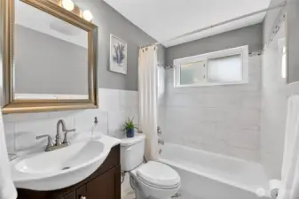 Main floor full bathroom. Tile floor and surround.