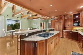 Built in Kitchen aid Refrigerator with frameless, Brazilian Cherry Cabinetry. Expansive island with seating for 6.