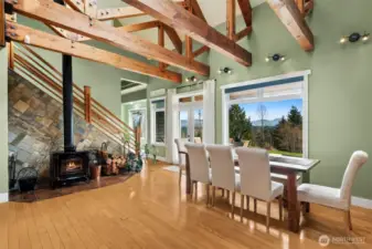 Adjacent to the Kitchen the family room/optional dining room/flex room has a 12' open beam ceiling. The home stays cozy and warm with the wood burning Napoleon free standing stove. The main floor has 9' ceilings and 75 year old exposed, recycled beams. While the home also has a  new Heat Pump added in 2022 the studio uses wall heaters.