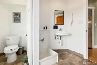Main floor mud/laundry room off of front deck. Half bath, dog washing sink, and lots of storage. Flooring is commercial grade marmolian.