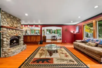 The main living room with river rock stone surrounding the gas fireplace