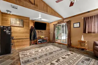 This is one of the bedrooms located downstairs and has access from the bedroom to the deck out back