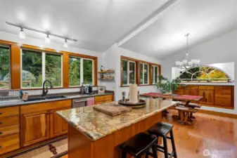 Vaulted ceilings in the Kitchen and dining room and so much natural lighting  including a lovely island to prep food and entertain guest