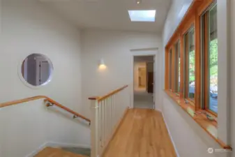 Hallway to Primary on main level and stairwell leading to lower level