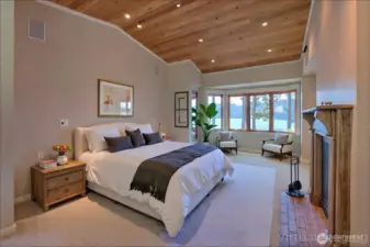 Beautiful Primary bedroom with views,  fireplace and second door leading to flex room that leads to kitchen  - virtually staged