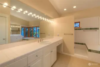 Primary bathroom with two vanities and separate water closet