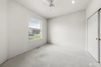 Second bedroom with carpet and ceiling fan. Large closet.