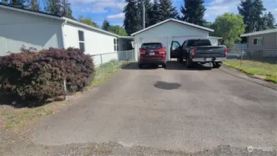 2-car garage and rv parking on the right side of the fence.