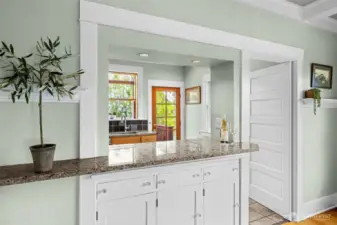 Original Swing door to kitchen and built in cabinets under Isand