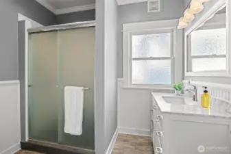 Updated hallway 3/4 bath with marble sink counter top and tiled flooring