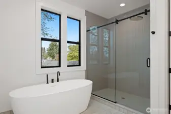 Deep free-standing soaker tub and spacious fully tiled shower
